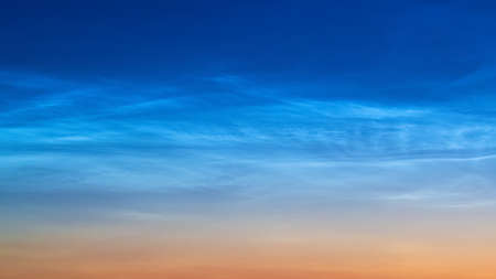 White Spindrift clouds on blue skyの写真素材