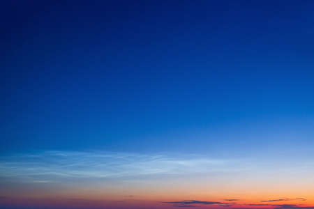 White Spindrift clouds on blue skyの写真素材