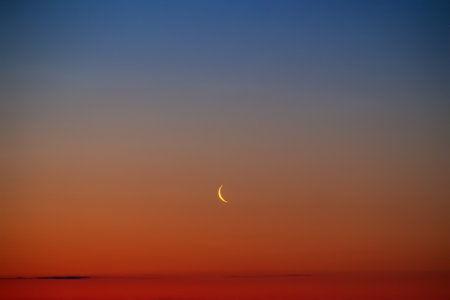 Sunset or sunrise with clouds. Red sunset and moon. beautiful sky. Prayer time. Generous Ramadan. Mubarak background.の写真素材