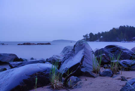 Lake Ladoga on a cloudy day. Stones and water are like fog. Long exposure.の写真素材