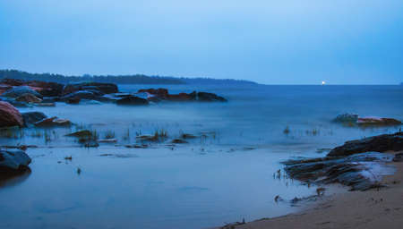 Lake Ladoga on a cloudy day. Stones and water are like fog. Long exposure.の写真素材