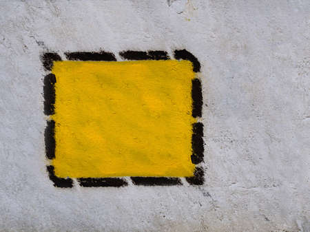 Yellow triangle, square, rhombus in black dotted frame on the old common wall. copy spaceの写真素材