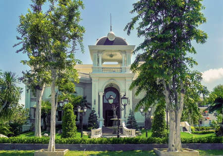 One beautiful two-story house with palm trees, trees, and landscape design in the summer. An Vien. Nha trang. Vietnam.の写真素材