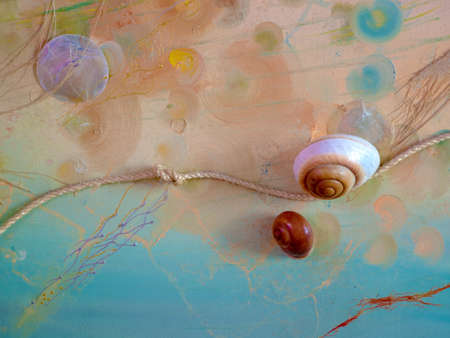 Handicraft on the marine theme. shells, starfish, rope with knots on the sea backgroundの写真素材
