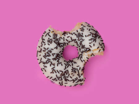 Donuts with icing on pastel pink background. Sweet donuts.の写真素材