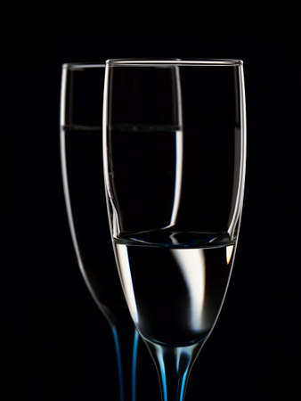 Elegant picture of glasses with clear water on a black backgroundの写真素材