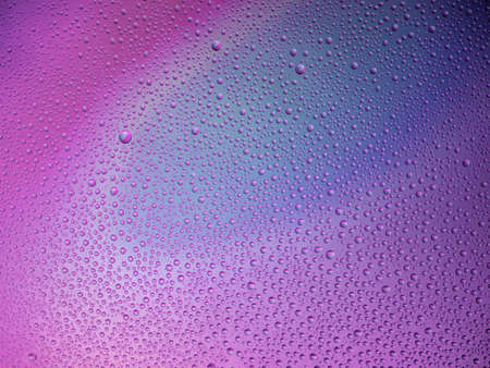 Water droplets on the glass with a colored background. Drops of water.の写真素材