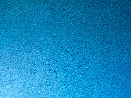 Water droplets on the glass with a colored background. Drops of water.の写真素材