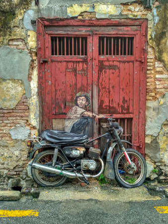 PENANG, MALAYSIA-2018-01-05: General view of a mural 'Boy on a Bike' painted by Ernest Zacharevic in Penang on July 6, 2013. The mural is one of the 9 murals paintings in early 2012のeditorial素材
