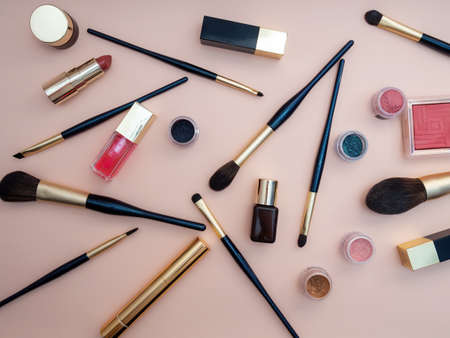 set of beauty cosmetics for female face and eye makeup on pink background . photoの写真素材