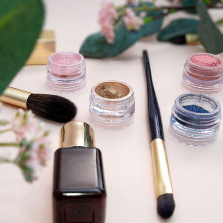 set of beauty cosmetics for female face and eye makeup on pink background . photoの写真素材