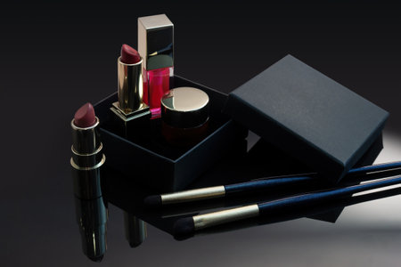 set of cosmetics for a female face and eye makeup in a black craft box on a pink background. photoの写真素材