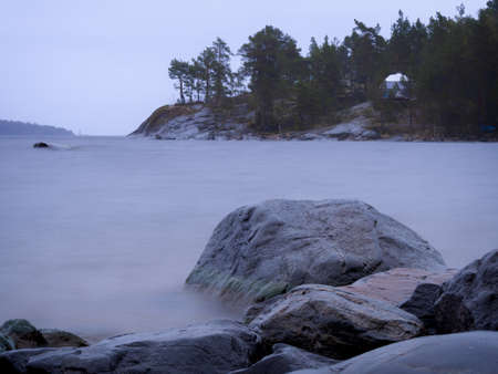 Lake Ladoga on a cloudy day. Stones and water are like fog. long exposure. photoの写真素材