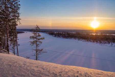 Top view of a winter landscape - frozen river and snowy forestの写真素材