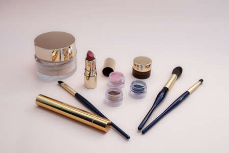 set of beauty cosmetics for female face and eye makeup on pink background . photoの写真素材