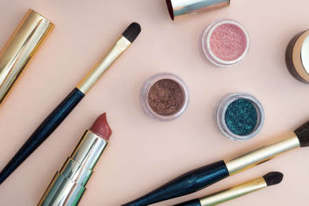 set of beauty cosmetics for female face and eye makeup on pink background . photoの写真素材