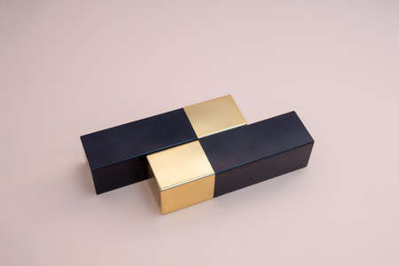 red lipstick in a gold case on a pink background. photoの写真素材