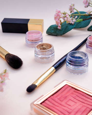 set of beauty cosmetics for female face and eye makeup on pink background . photoの写真素材