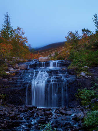 Beautiful mountain waterfall among rocks in polar summer in Khibiny Mountains. Kola Peninsula, Arctic, polar summer. photoの写真素材
