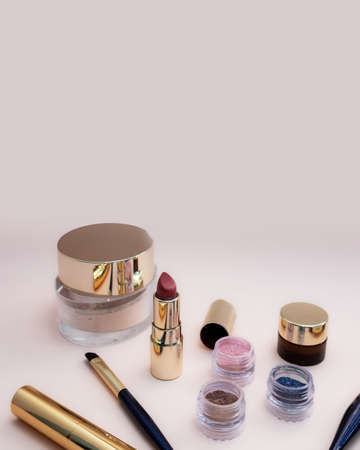 set of beauty cosmetics for female face and eye makeup on pink background . photoの写真素材