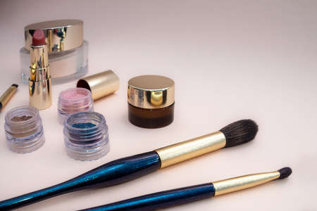 set of beauty cosmetics for female face and eye makeup on pink background . photoの写真素材
