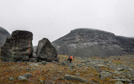 Hiker woman walking in a mountain rocky path. photoの写真素材