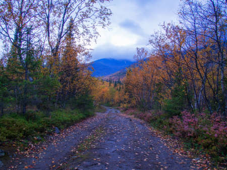 Dirt gravel road with mountains in the background. Autumn mountains of Khibiny. photoの写真素材