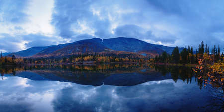 Reflection of mountains and clouds in the calm surface of the lake. Peaceful landscape. Khibinyの写真素材