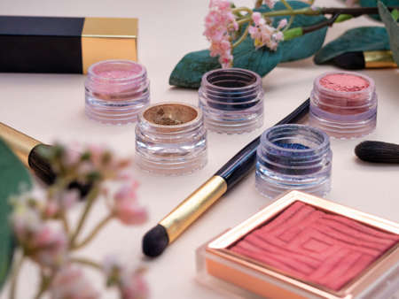 set of beauty cosmetics for female face and eye makeup on pink background . photoの写真素材