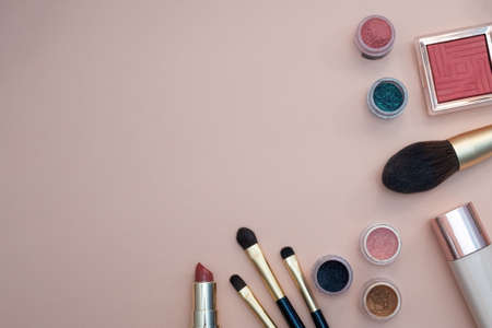 set of beauty cosmetics for female face and eye makeup on pink background . photoの写真素材