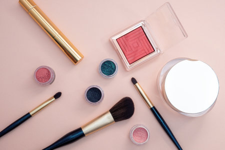 set of beauty cosmetics for female face and eye makeup on pink background . photoの写真素材