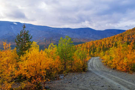Dirt gravel road with mountains in the background. Autumn mountains of Khibiny. photoの写真素材