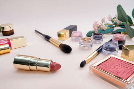 set of beauty cosmetics for female face and eye makeup on pink background . photoの写真素材