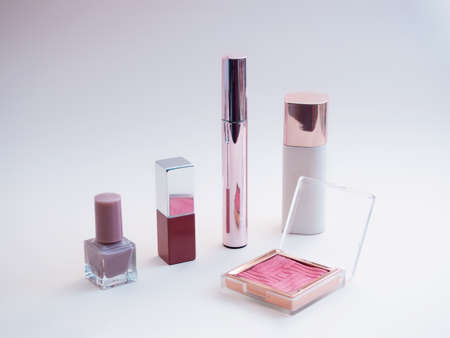 set of beauty cosmetics for female face and eye makeup on pink background . photoの写真素材