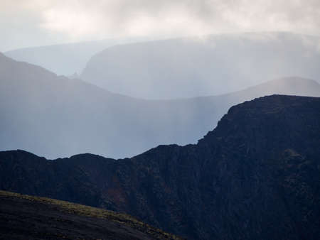 mountain peaks in the clouds. A chain of gray mountains in the backlight. Khibiny. photoの写真素材