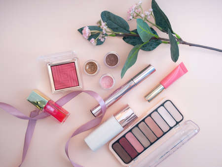 set of beauty cosmetics for female face and eye makeup on pink background . photoの写真素材