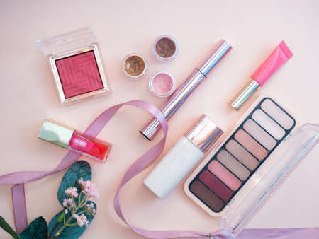 set of beauty cosmetics for female face and eye makeup on pink background . photoの写真素材