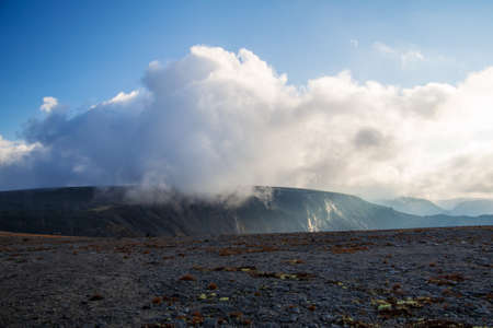 Mountain peaks in the clouds. A chain of gray mountains in the backlight. Khibinyの写真素材