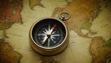 An ancient compass lies open on an antique world map. The golden tones of aged paper and the intricate details of the compass evoke a sense of historical exploration and discovery.の素材