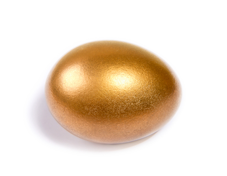 gilt Easter eggs lying on a white backgroundの写真素材