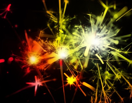 colorful festive sparklers on the black backgroundの写真素材