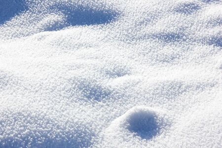 The ground is covered with snow, blue gentle backgroundの写真素材
