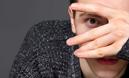 a young man in a gray sweater on a gray background studioの写真素材