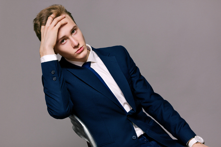 a young man in a suit model in a beautiful postureの写真素材
