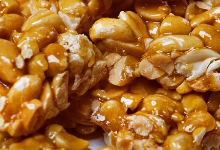 Candied roasted peanuts  isolated on white backgroundの写真素材