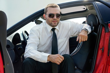 young male model in the cabin of the carの写真素材