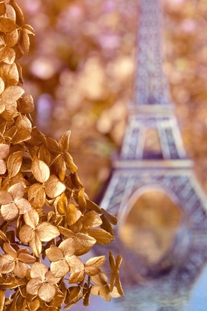 Eiffel Tower on the background of gold leaves and flowers