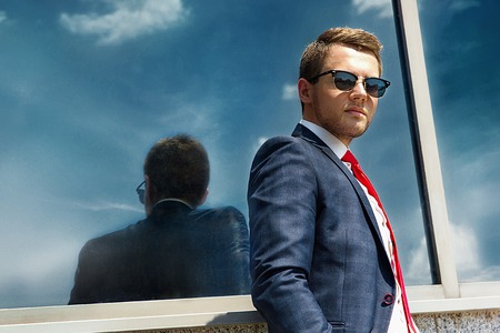 portrait of businessman in sunglasses on the background of the cityの写真素材