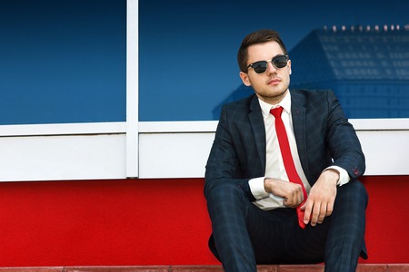 portrait of businessman in sunglasses on the background of the cityの写真素材