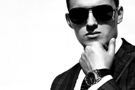 a handsome young man in sunglasses sunlitの写真素材